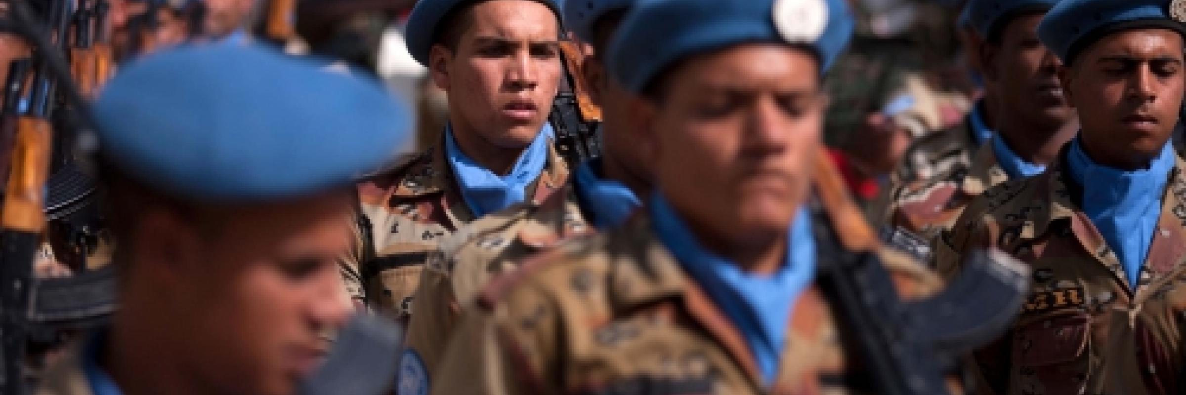 Image of a group of troops wearing blue berets