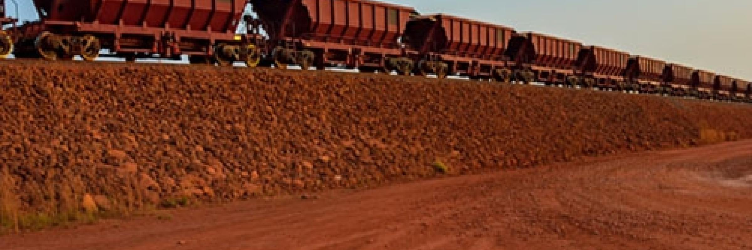 Train trucks passing through a harsh landscape