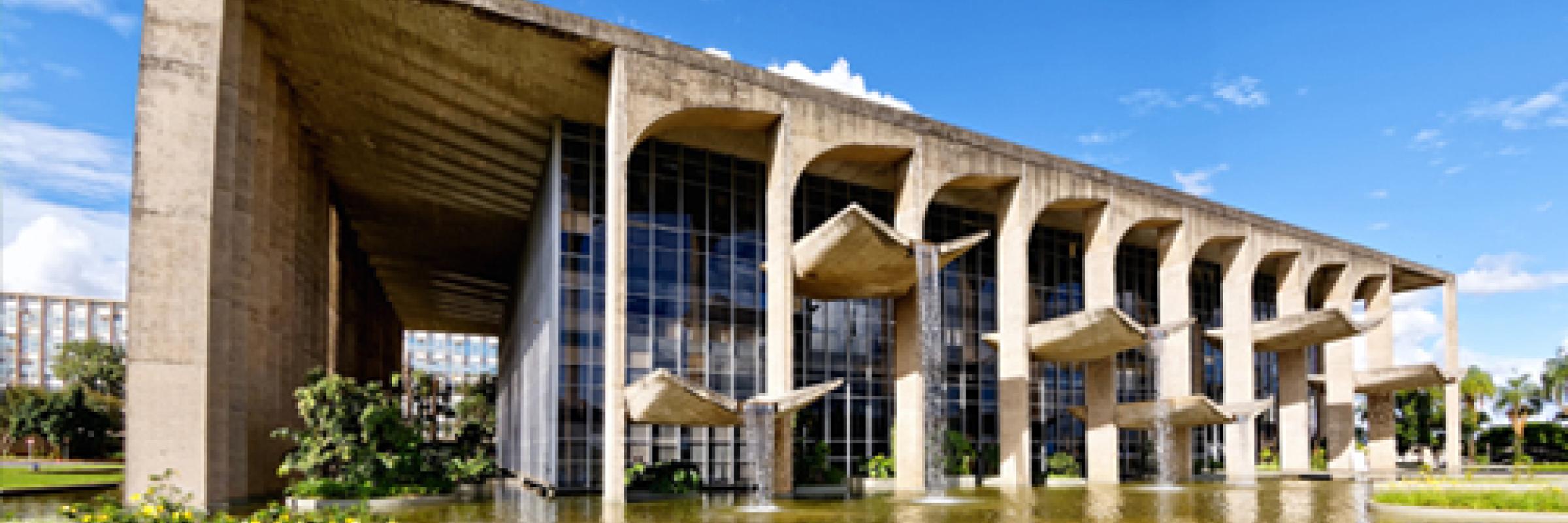 An image of a building with a large pond in front of it