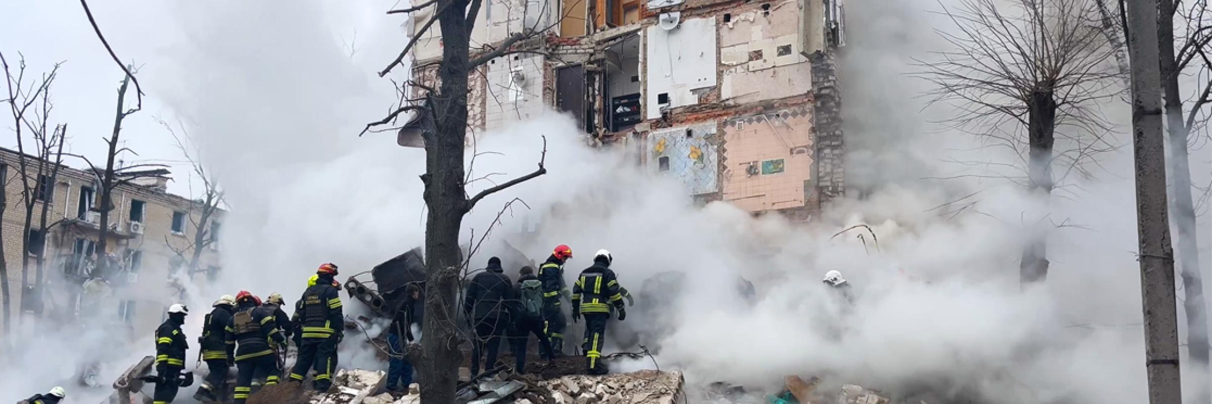 a group of firefighters standing near a building