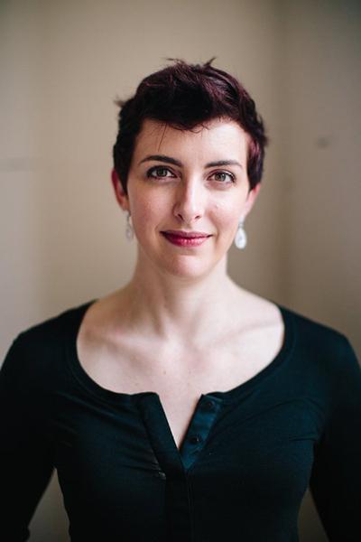 Image of a woman wearing a black top smiling at the camera