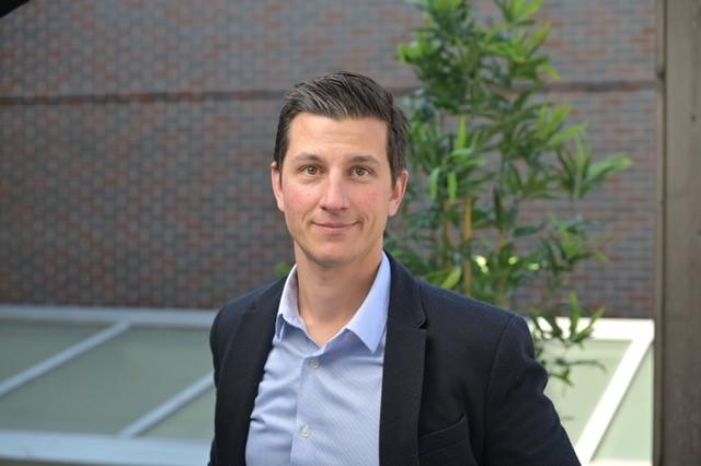 Image of a man wearing a suit smiling at camera