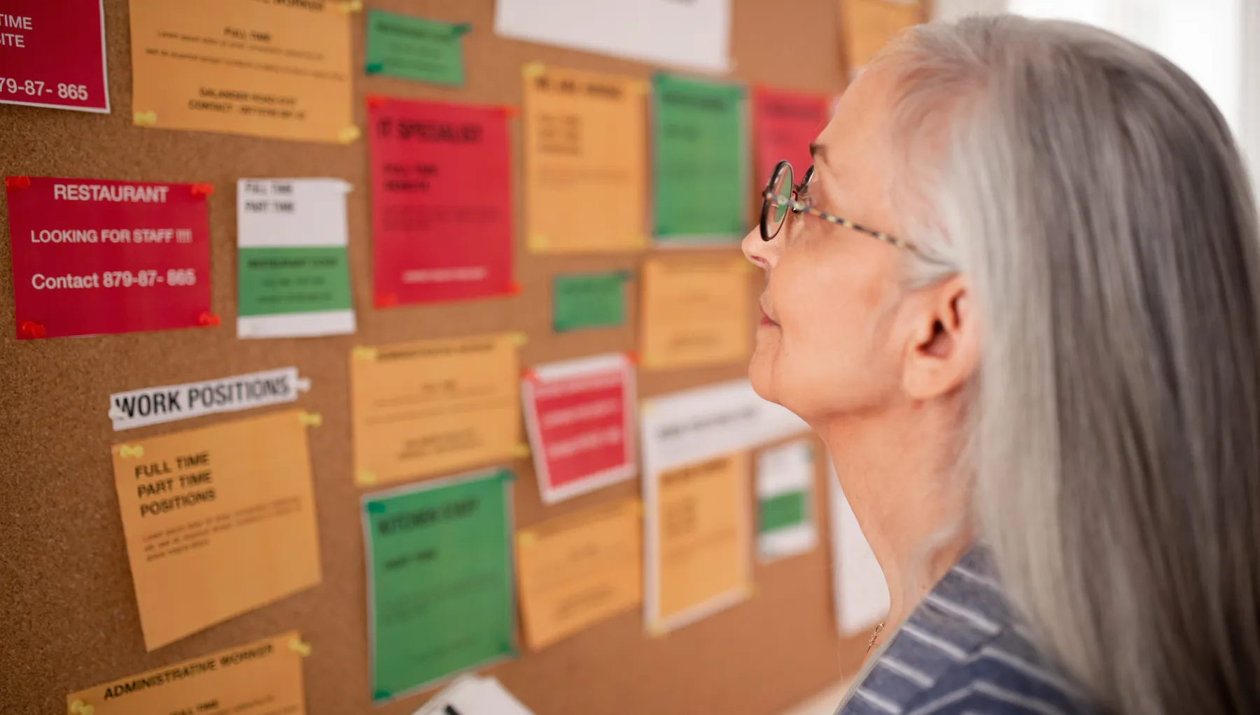 image of a woman looking at a jobs board